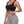 Three-quarter view on the model in the black yoga bra, worn with grey high-waisted shorts