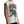 Three-quarter view on the model, the deep armhole leaving the shoulder and arm uncovered