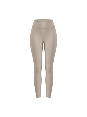 The khaki leggings shown on a form from the side, the high rise and close fit down the leg