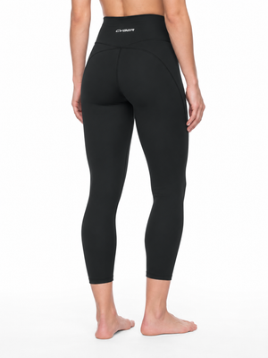 Back view on a model in the black yoga leggings, the contour seams curving under the seat