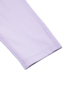 Close-up of the purple hem at the ankle, folded under and stitched flat around the leg