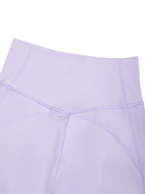 Close-up of the purple back, the contour seams meeting in a V below the waistband