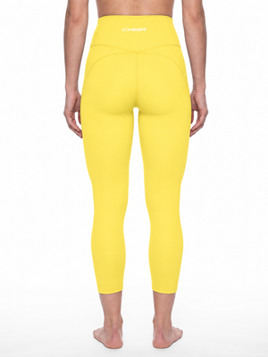 Back view on a model in the lemon yellow yoga leggings, the seams shaping the seat