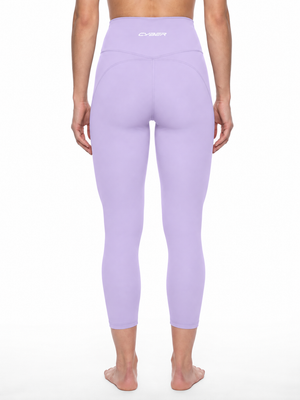 Back view on a model in the purple high waisted yoga leggings, contour seams under the seat