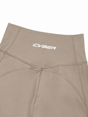 Close-up of the khaki back waistband, the CYBER wordmark above the V-shaped seam