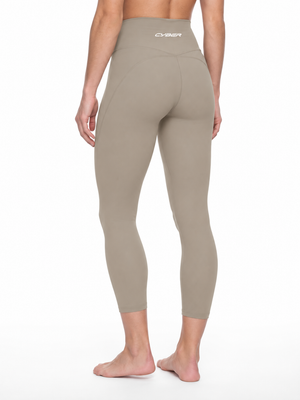 Three-quarter back view on the model in khaki, the high rise and cropped length at the ankle