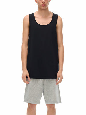 Cyber Loose Black Muscle Shirt on a model, front view, the loose body falling over grey shorts