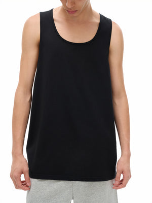 Closer front view on the model, the scoop neck and wide armholes over the shoulders
