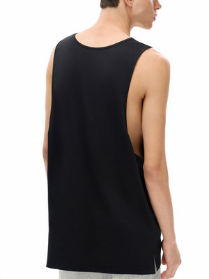 Three-quarter back view on the model, the deep armhole showing the open side of the tank