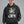 Man wearing the Y2K streetwear hoodie in faded black, front view of the washed finish and the eyes graphic print
