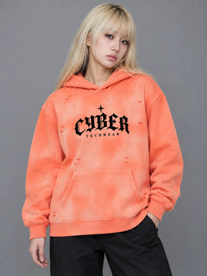Model with long blonde hair in the Orange sun faded hoodie, hand in the pocket, front view of the CYBER print