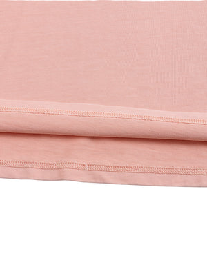 Close-up of the cropped hem of the pink washed tee, double stitching along the bottom edge