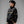 Cyberpunk Racing Jacket in black worn zipped, three-quarter view showing sleeve prints and gold-tone piping
