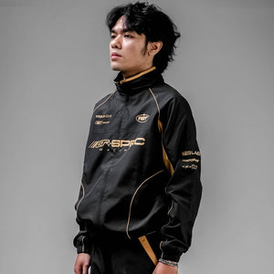 Cyberpunk Racing Jacket in black worn zipped, three-quarter view showing sleeve prints and gold-tone piping