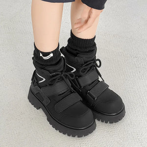 Deconstructed high top techwear boots, close-up on exposed panel seams