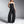 Black denim strapless jumpsuit with multiple cargo pockets and a wide leg