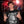 A model at a concert wears the black tank, cyborg portrait and script printed large across the chest