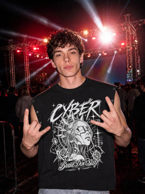 A model at a concert wears the black tank, cyborg portrait and script printed large across the chest