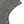 Close-up of one armhole, a row of metal eyelets set through the washed cotton along the edge