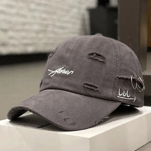 Green distressed baseball cap with script embroidery and a brim ring