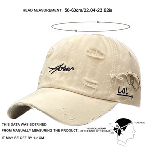 Green distressed baseball cap with script embroidery and a brim ring