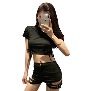 Black high waist goth shorts with a black crop top, front view on white, buckled straps over thigh slits