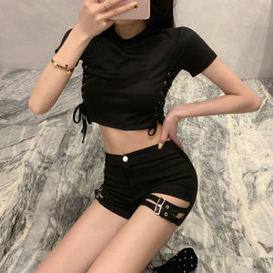 Double Buckle Goth Shorts worn in three-quarter view, hand on hip, double strapped cut-out on the leg