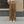 Brown parachute y2k pants on a woman in a white crop tee, front view of the baggy legs and thigh cargo pockets