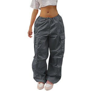 Grey Drawstring Parachute Y2K Pants on a white background, front view of the drawstring waist and flap pockets