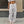 White drawstring parachute pants on a city sidewalk, front view of the baggy legs and large flap cargo pockets