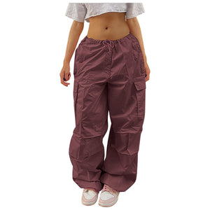 Wine Red baggy parachute cargo pants on a white background, front view of the low drawstring waist
