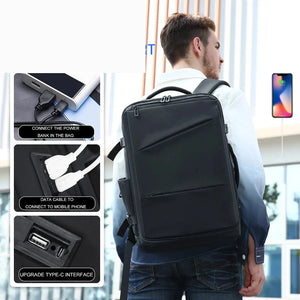 Black business backpack with an expandable main compartment and a luggage strap