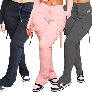 Front view of three pairs of flared cargo pants in black, pink and dark grey, drawstring waists and flared hems