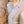Light Grey flare cargo pants on a woman, front view of the drawstring waist and the square thigh flap pocket