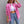 Pink oversized frayed jacket with sunglasses, hand on the head, front view over a crop top and jeans