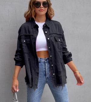 Black frayed denim jacket worn open over a white crop top, front view with sunglasses and light jeans