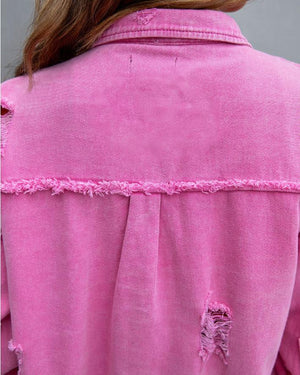 Close-up of the Rose Red jacket back, frayed raw edge across the yoke and a ripped patch below