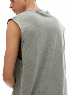 Close view over the model's shoulder, the raw armhole edge curling slightly with wear