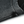 Close-up of the hem, stitched once and left to fray along the cut line of the knit
