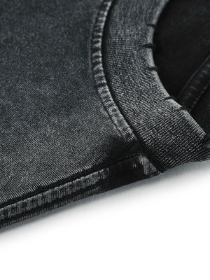 Close-up of the hem, stitched once and left to fray along the cut line of the knit