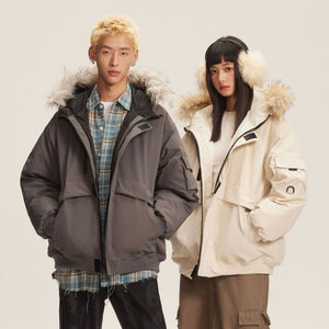 Man in the Dark Gray parka over a flannel shirt and woman in the Apricot parka, front view, studio shot