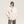 Woman in the Pink Fur Hood Parka Y2K Jacket, front view with hands in pockets and wide grey jeans