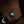 Glowing Moon Y2K Necklace worn in the dark, the crescent pendant glowing turquoise at the collarbone