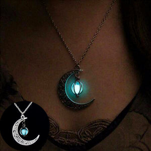 Glowing Moon Y2K Necklace worn in the dark, the crescent pendant glowing turquoise at the collarbone