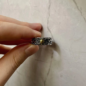Golden Sun Textured Y2K Ring held between fingers against a marble wall, side view of the band