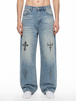 Goth Cross Y2K Baggy Jeans on a model, front view, light vintage wash with black gothic motifs on both legs