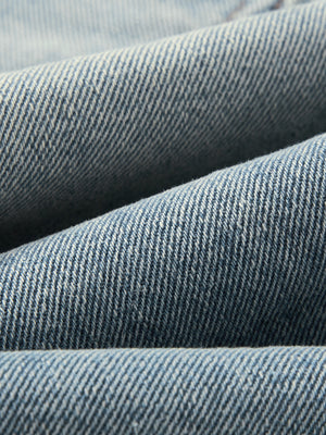 Folds of the washed denim laid over each other, showing the weight and thickness of the 470 gsm weave