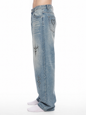 Side view on the model, the loose straight leg falling to a hem that stacks over white socks
