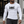 A man walks out of a gym in the white compression shirt with black trousers, the print across the chest