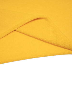 Hem detail in yellow, the raw unfinished edge folded back to show the inside face of the knit